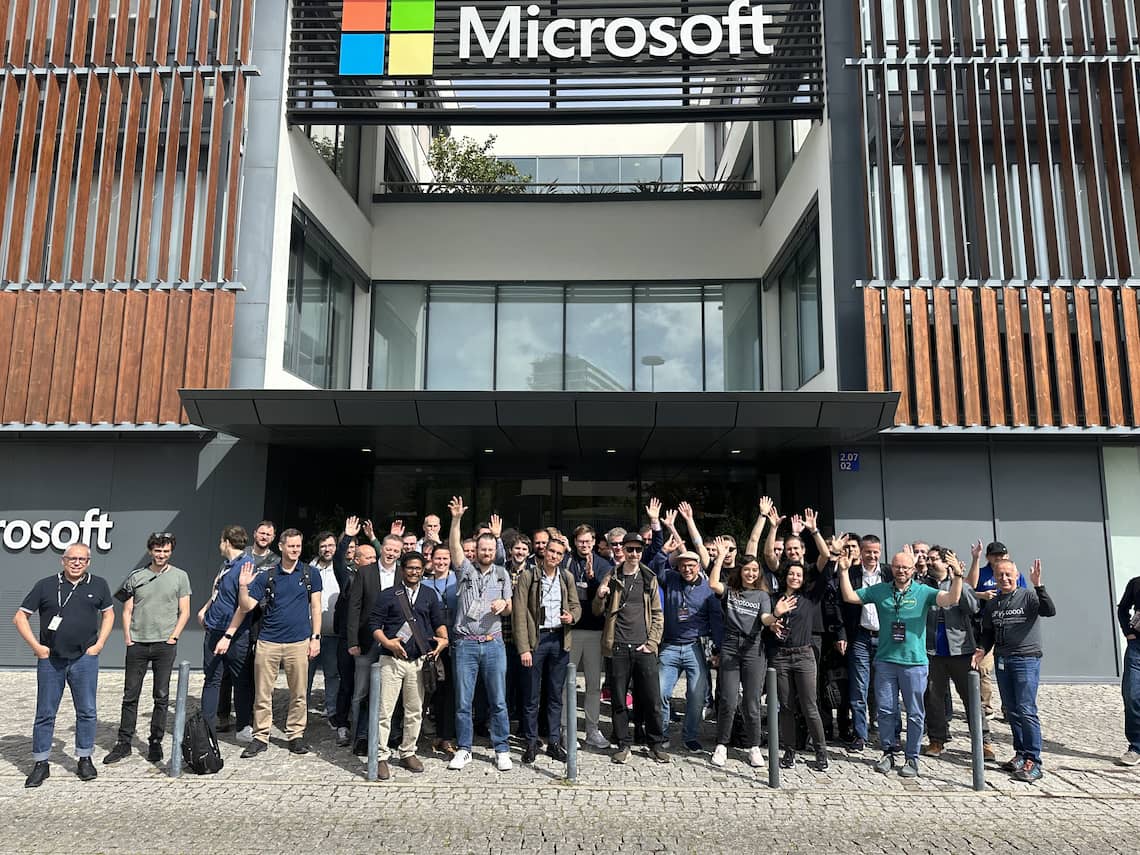 All attendees posing for a group photo in front of the Microsoft office in Lisbon.